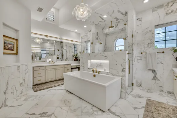 This exquisite luxury real estate photography showcases a stunning marble bathroom in a Gilbert, AZ property on E Hummingbird Way.