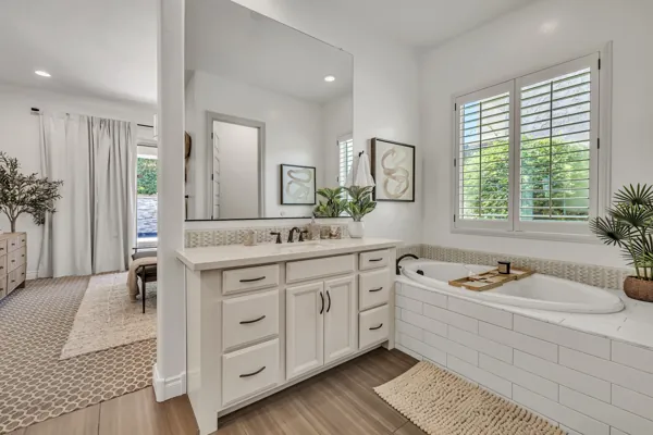 Explore this beautifully designed bathroom featuring a spacious vanity and soaking tub, captured in high-quality real estate photography, located in Mesa, AZ.