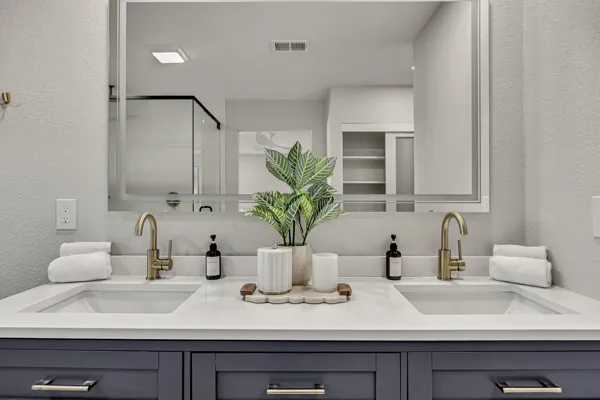This stunning real estate photography showcases a modern bathroom in Scottsdale, AZ, featuring dual sinks, elegant fixtures, and sleek design elements.