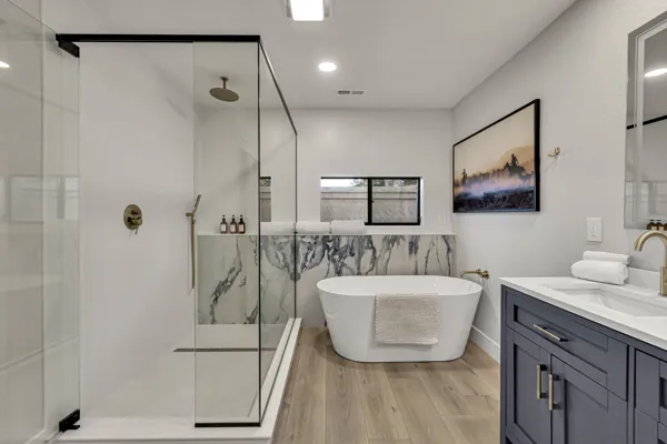 This real estate photography captures a luxurious modern bathroom in Scottsdale, AZ, featuring a glass shower and freestanding tub.