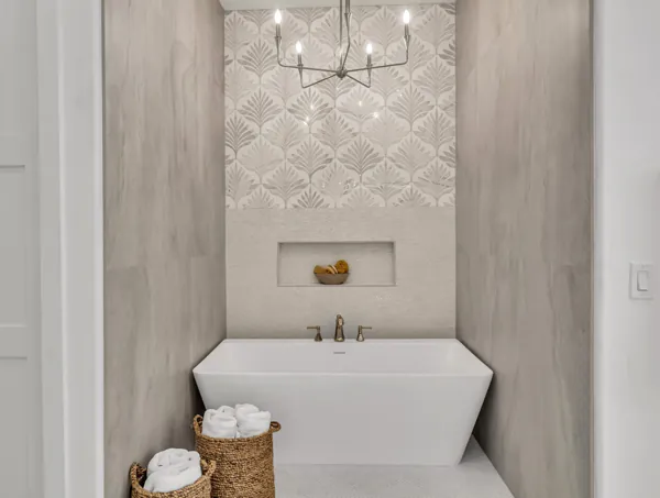 This stunning bathroom on E Caribbean Ln in Scottsdale, AZ, exemplifies modern real estate photography with its elegant freestanding tub and contemporary chandelier.