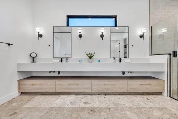 This modern bathroom vanity features a sleek design with dual mirrors and elegant lighting in a Scottsdale, AZ home, captured with professional real estate photography.