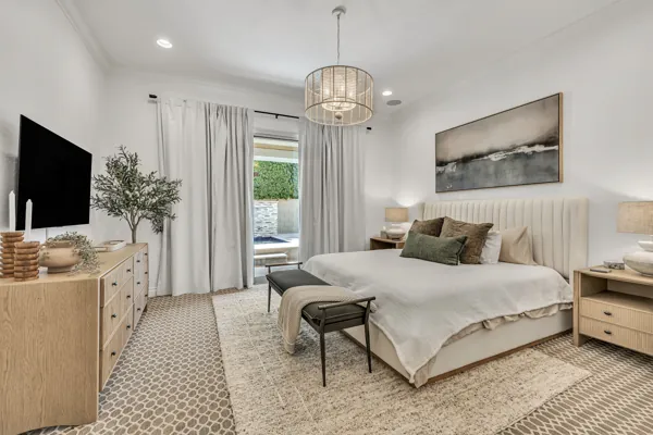 This real estate photography showcases a beautifully designed bedroom in a Mesa, AZ property, featuring modern decor and elegant lighting.