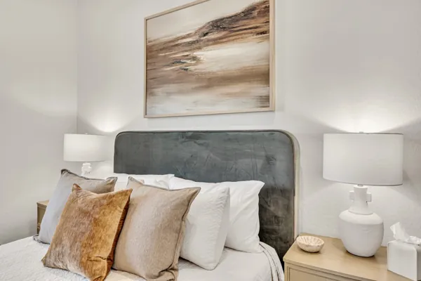 Explore this elegant bedroom in Mesa, AZ, featuring contemporary art and plush bedding ideal for showcasing real estate photography.
