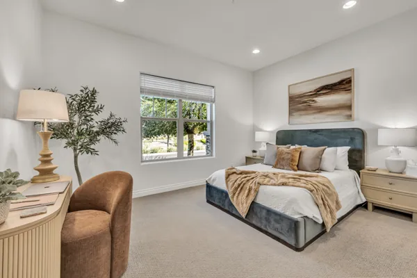 This elegant bedroom in Mesa, AZ showcases tasteful real estate photography, highlighting a serene space filled with natural light and modern furnishings.