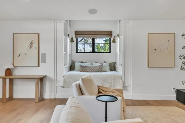 This luxury real estate photography captures a bright, modern bedroom on E Avalon Dr in Phoenix, AZ, highlighting its cozy daybed and elegant artwork.