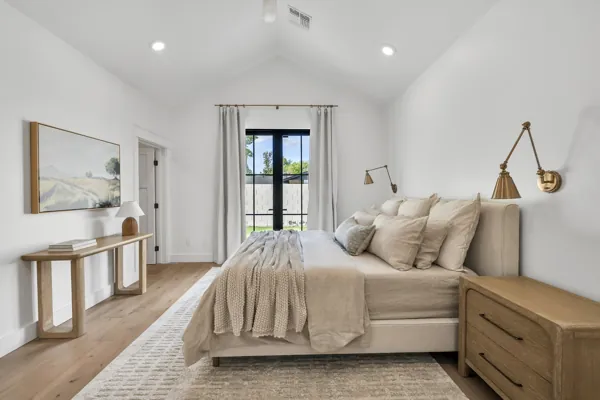 This luxury real estate photography showcases a beautifully designed bedroom in Phoenix, AZ, featuring elegant decor and abundant natural light.