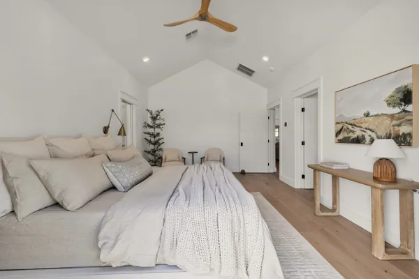 Discover luxury real estate photography showcasing a spacious modern bedroom in a Phoenix, AZ home, featuring elegant decor and furnishings on E Avalon Dr.
