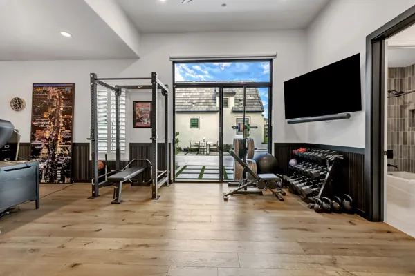 This luxury real estate photography showcases a modern home gym with premium equipment in Gilbert, AZ, highlighting upscale living.