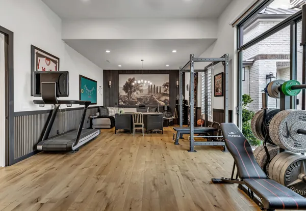 This luxury real estate photography captures a stunning home gym in Gilbert, AZ, featuring modern equipment and elegant design.