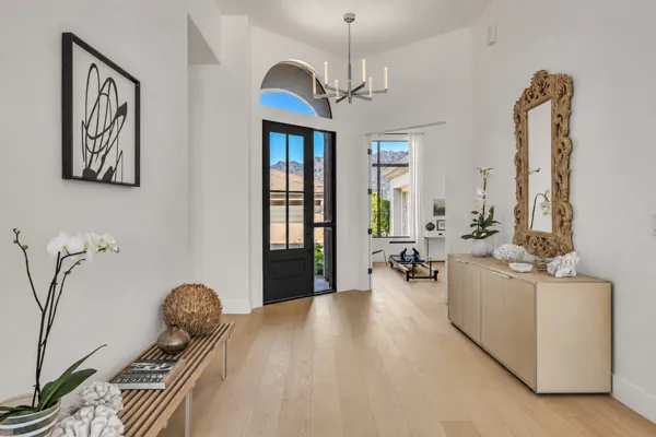 This real estate photography showcases a stylish entryway in a Scottsdale, AZ home, highlighting modern art and chic decor.