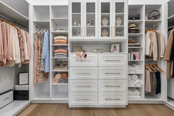 Explore this spacious and well-organized walk-in closet in a Scottsdale, AZ home, showcasing elegant storage solutions in real estate photography.