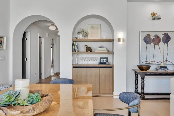 This luxury real estate photography in Scottsdale, AZ showcases a beautifully designed dining room with elegant decor and arched architecture.