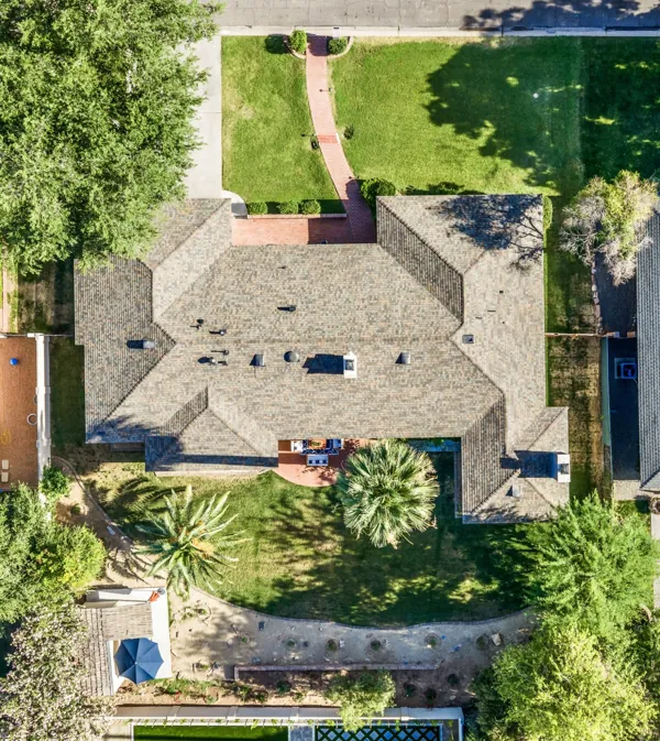 Aerial real estate photography of a residential house with a spacious backyard and greenery in Phoenix, AZ, showcasing the property layout and landscaping.