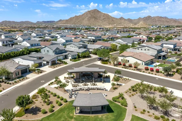 This real estate photography captures a stunning aerial view of the residential neighborhood against a mountainous backdrop in San Tan Valley, AZ.