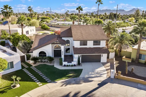 Aerial real estate photography showcasing a spacious suburban home with a well-maintained front yard in Scottsdale, AZ, highlighting its curb appeal and neighborhood setting.