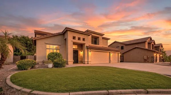 This beautiful desert-style home in Gilbert, AZ, showcases excellent real estate photography, highlighting the stunning architecture and vibrant sunset backdrop.