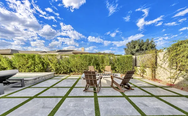 Experience luxury real estate photography capturing a stunning patio with elegant seating and paved tiles in Gilbert, AZ, showcasing outdoor living at its finest.