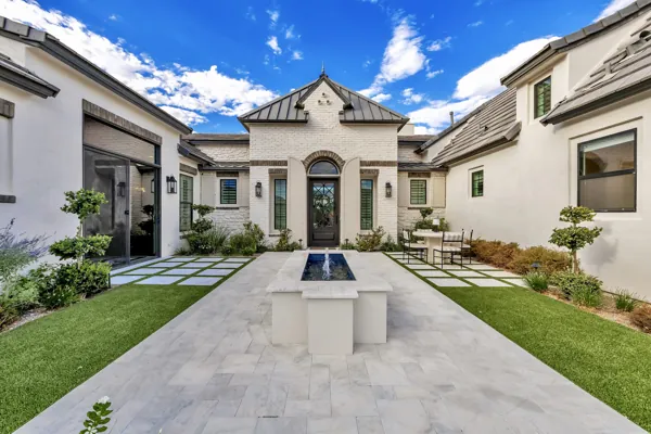 This luxury real estate photography showcases a modern courtyard with a fountain in a stunning home on E Hummingbird Way, Gilbert, AZ.