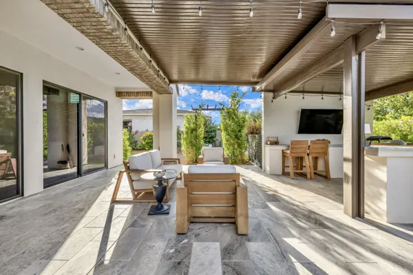 Experience luxury real estate photography with a stunning outdoor lounge area in Gilbert, AZ, featuring modern furniture and entertainment amenities.