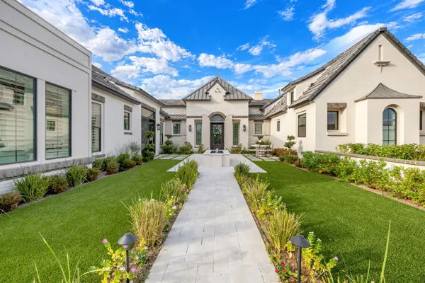 Discover luxury real estate photography capturing a stunning Mediterranean-style home in Gilbert, AZ, showcasing beautiful architecture and lush landscaping.
