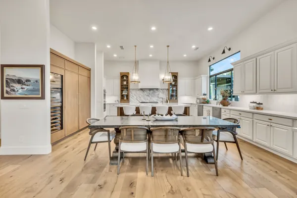 This luxury real estate photography showcases a stunning kitchen in Gilbert, AZ, featuring a spacious island and elegant design elements.