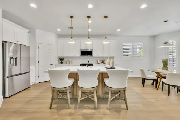 This bright modern kitchen with an island and dining area offers stylish living in Gilbert, AZ, featuring real estate photography in the Morrison Ranch neighborhood.