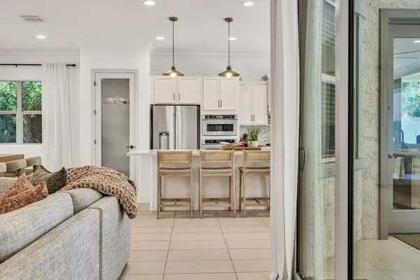 This stunning real estate photography showcases a bright and modern kitchen with island seating, located in Mesa, AZ, offering a glimpse into sophisticated home design.