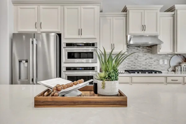 Stunning modern kitchen showcased in real estate photography in Mesa, AZ, featuring sleek appliances and elegant decor.