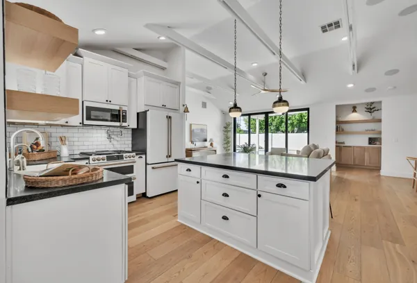 This luxury real estate photography showcases a spacious kitchen in Phoenix, AZ with a modern design and large island.