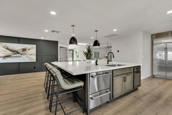 Explore this beautifully designed kitchen featuring a spacious island and stainless steel appliances in Scottsdale, AZ, showcasing excellent real estate photography.
