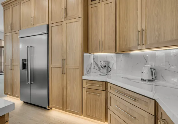This real estate photography showcases a modern kitchen in Scottsdale, AZ, featuring elegant wood cabinets and stainless steel appliances.