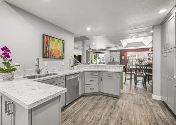 Discover luxury real estate photography showcasing a modern kitchen in Scottsdale, AZ, featuring marble countertops and elegant wood flooring for a sophisticated ambiance.