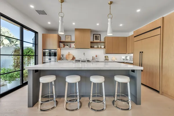 This luxury real estate photography captures a modern kitchen on e Joshua Tree Ln, showcasing sleek design in Scottsdale, AZ.