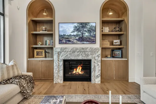 Experience luxury real estate photography showcasing an elegant living room with a marble fireplace in Gilbert, AZ.
