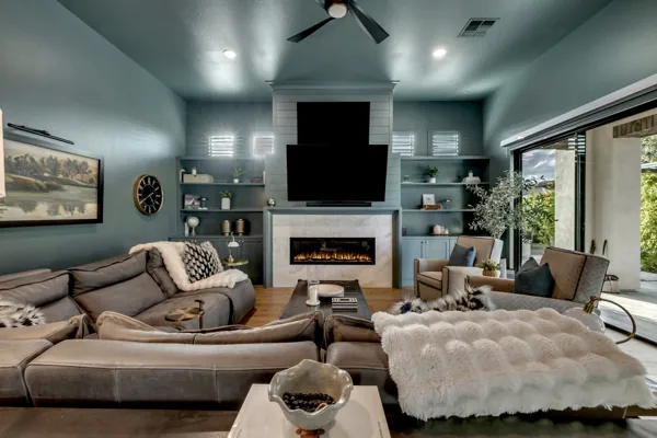 Explore this luxurious living room with a modern fireplace in Gilbert, AZ, showcasing premium real estate photography.