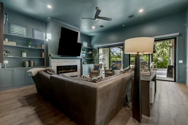 Discover luxury real estate photography showcasing a stunning living room in Gilbert, AZ, featuring a modern fireplace and expansive outdoor views.