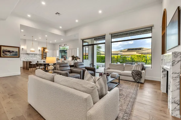 Discover luxury real estate photography showcasing a stunning living room in Gilbert, AZ, with elegant furnishings and expansive windows.