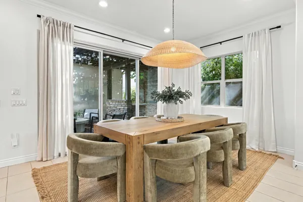 Beautiful dining area with a wooden table and chairs showcasing real estate photography in Mesa, AZ.