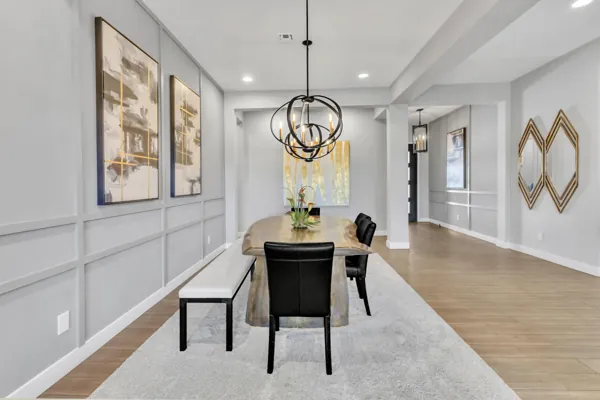 This modern dining room interior features elegant lighting and stylish seating, showcasing excellent real estate photography in Phoenix, AZ.