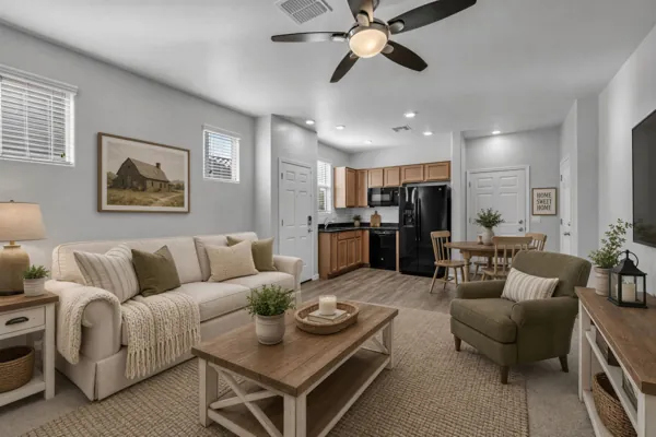 This beautifully staged open-plan living room and kitchen in San Tan Valley, AZ, showcases the appeal of real estate photography in capturing inviting spaces.
