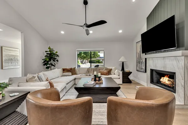 This beautifully designed living room in Scottsdale, AZ, showcases stunning real estate photography with a cozy fireplace and contemporary decor.