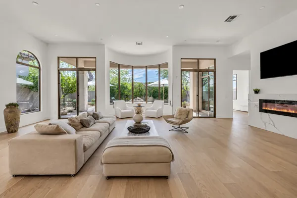 This real estate photography captures a luxurious living room in Scottsdale, AZ, featuring floor-to-ceiling windows and elegant furnishings.