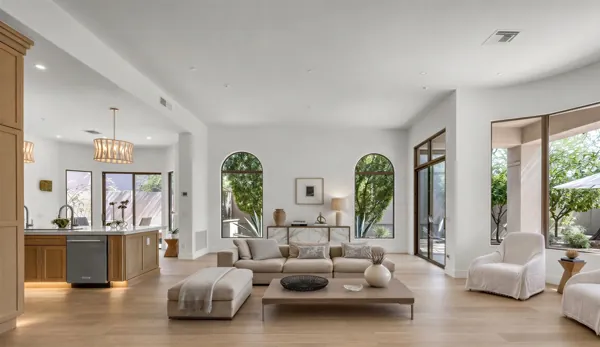 This Scottsdale, AZ home features a modern, bright living room with stylish furniture and large windows, highlighted in real estate photography.