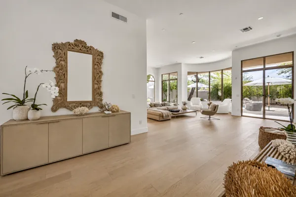 This stunning real estate photography captures a modern living room in Scottsdale, AZ, featuring large windows and stylish decor.