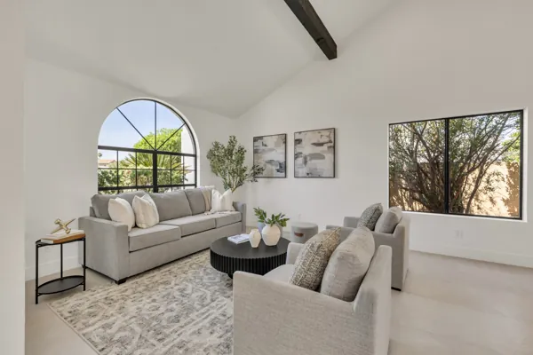This bright living room in Scottsdale, AZ features modern gray furniture and large windows, captured perfectly with professional real estate photography.