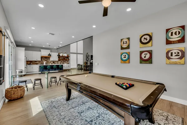 This stylish Airbnb photo shoot location in Scottsdale, AZ, features a modern game room with a pool table and a beautifully designed kitchen.