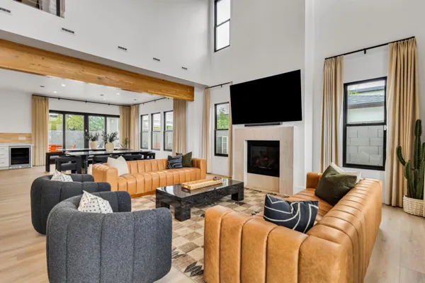 This modern living room in Scottsdale, AZ features a spacious open floor plan with leather sofas and large windows, showcased through professional real estate photography.