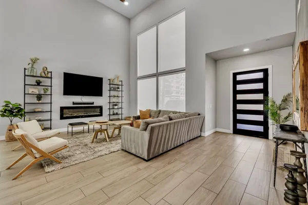 This stunning Airbnb photo shoot captures a modern living room in Scottsdale, AZ, featuring high ceilings and elegant decor, perfect for showcasing stylish real estate.