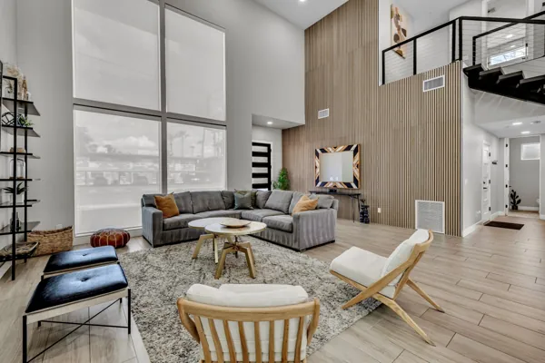 This stylish living room in Scottsdale, AZ features modern design and ample natural light, ideal for an Airbnb photo shoot showcasing elegant interiors.
